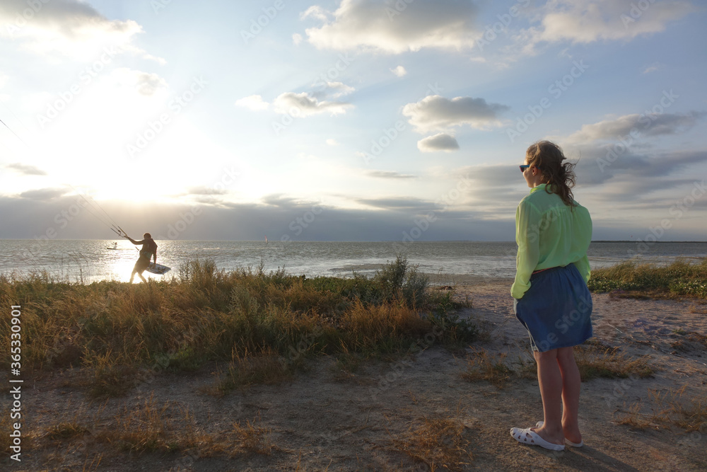 girl on the beach watching the sunset