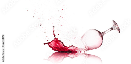 Red Wine Glass dropped and spilling over a white background
