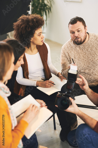 Attendees attending a photography course in studio.