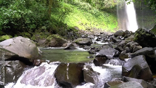 La Fortuna Waterfall in the rainforest near Arenal Volcano in Costa Rica, Central America. Beautiful nature landscape at toursit travel destination landmark.