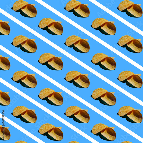 Pattern of light brown potato chips on a light blue background with white stripes