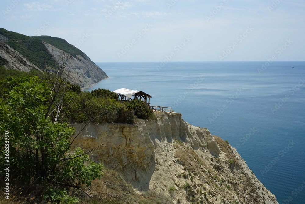 A beautiful view of the sea and mountain cliffs from the top of one of them on a clear sunny day. Black Sea coast near the city of the Anapa resort. 