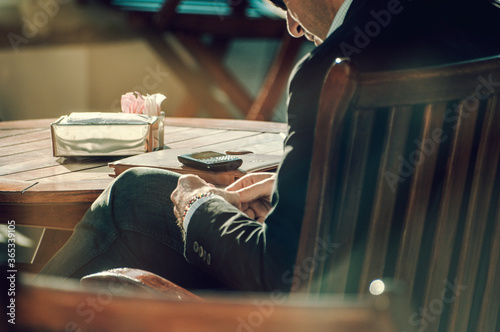 Businessman sitting in a cafe waiting for a phone call
