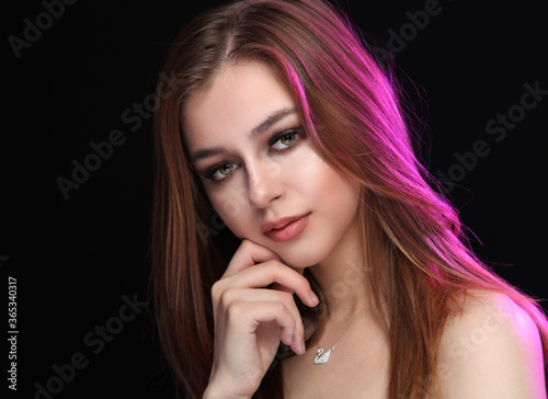 Girl on a dark background with purple backlight