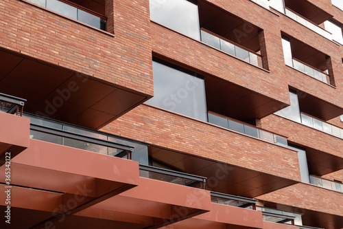 Texture view of beautiful red bricks modern building with large windows. New district architecture close-up in Oslo, Norway