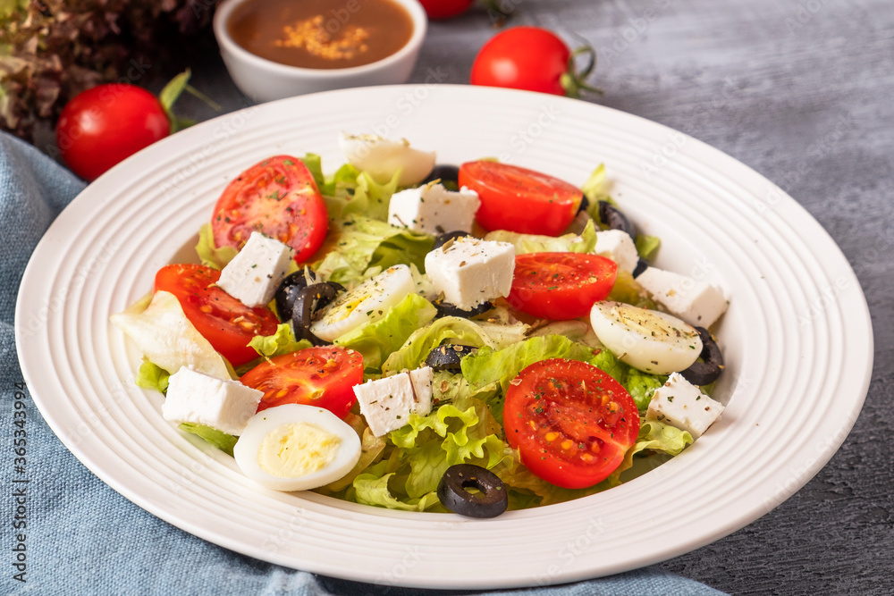 Colorful vegetables with quail eggs and cheese on a plate. Healthy food concept. Lifestyle Colorful vegetables with quail eggs and cheese on a plate. Healthy food concept. Lifestyle