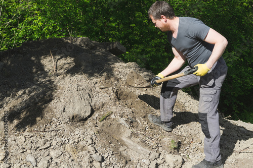 A man spreading soil masse around.