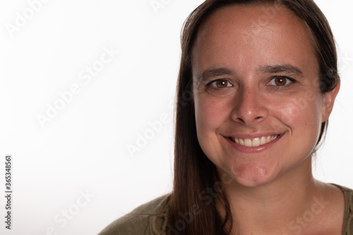 Tightly cropped headshot of female student isolated on white background with room for copy to the left