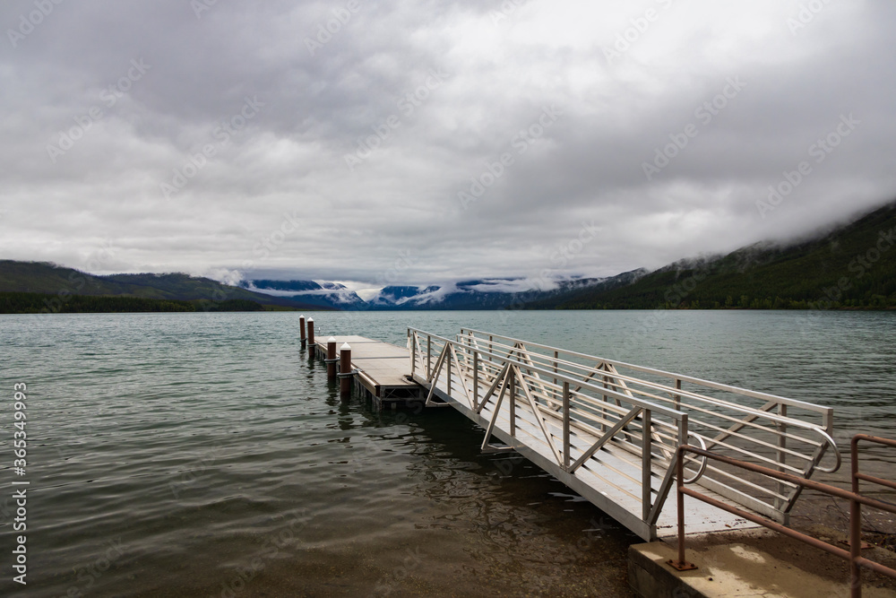 Pier with mountain-range background at Lake McDonald, Glacier National Park, Montana