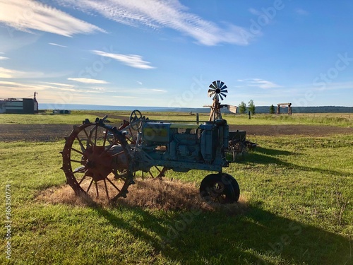 Tractor and an old-timey windmill photo