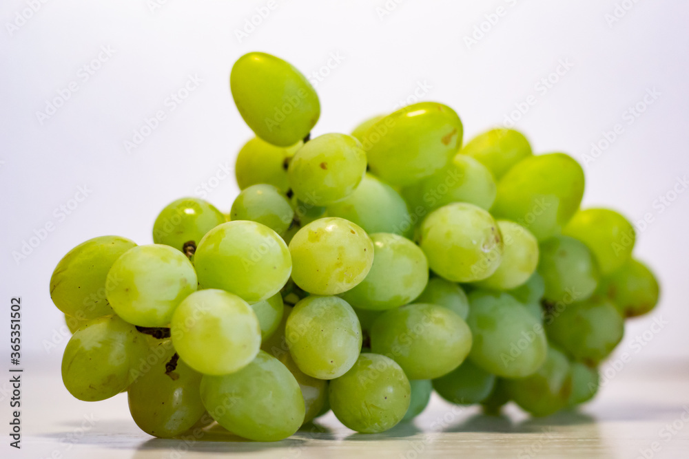 Bunch of Green Seedless Grape solated on white background.