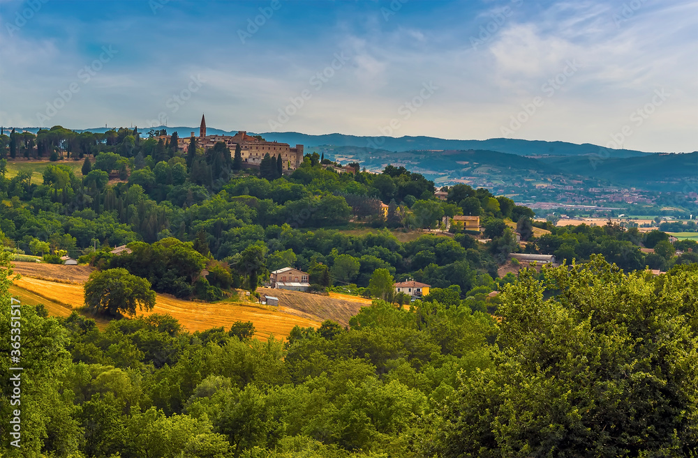 A view across the fields towards the Umbrian village of Collazzone near Todi, Italy in summer