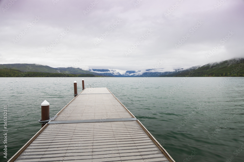 Obraz premium Pier with mountain-range background at Lake McDonald, Glacier National Park, Montana