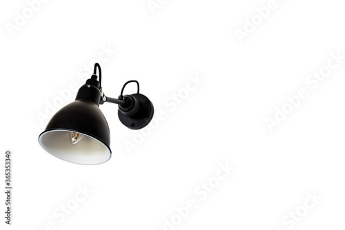 Close up isolated view of single Black and modern wall lamp on white wall