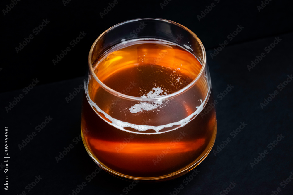 Glass of tasty beer. Light alcohol drink. Dark background. Glass of tasty beer. Light alcohol drink. Dark background.