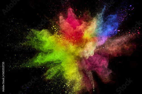 Colored powder explosion on black background. Freeze motion.