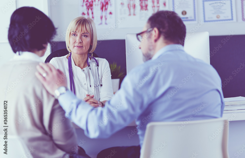 doctor talking to her male patient at office doctor talking to her male patient at office