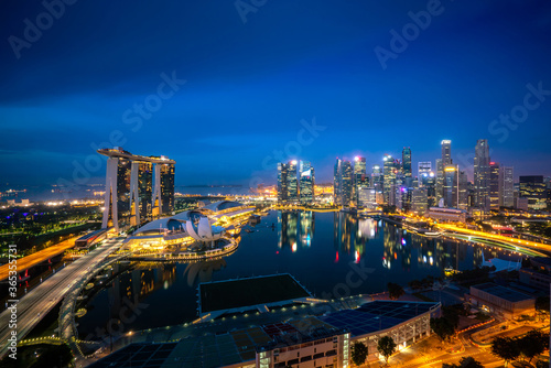 Panorama of Singapore business district skyline and office skyscraper at night in Marina bay, Singapore. Asian tourism, modern city life, or business finance and economy concept..