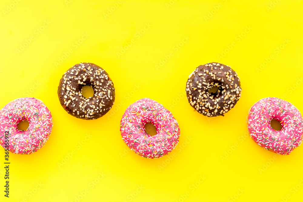 Colorful donuts pink and chocolate icing. Flat lay of bakery, above view Colorful donuts pink and chocolate icing. Flat lay of bakery, above view