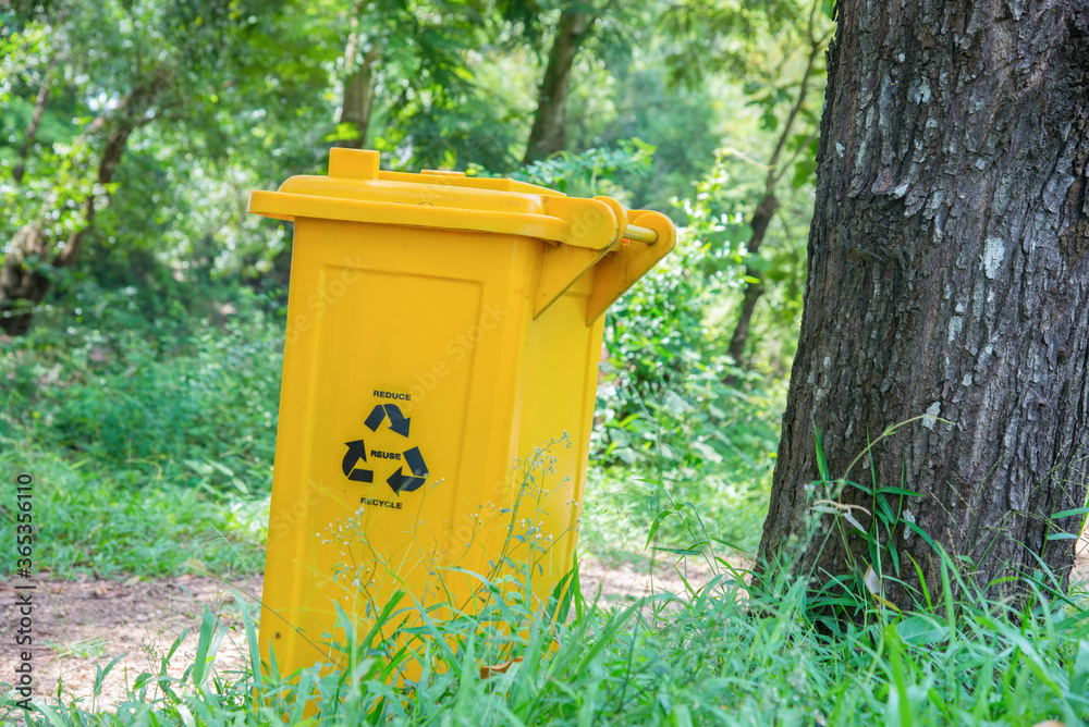 Yellow trash can is placed on the side of the road. Yellow trash can is placed on the side of the road.