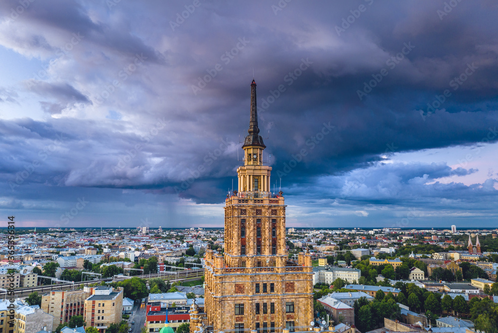 Aerial view of iconic Riga city in dramatic sunset. Modern architecture in Europe with storm clouds Aerial view of iconic Riga city in dramatic sunset. Modern architecture in Europe with storm clouds