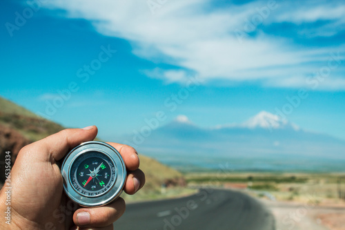 asphalt road, compass and mountain