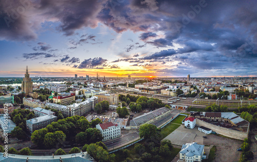 Aerial view of iconic Riga city in dramatic sunset. Modern architecture in Europe with storm clouds