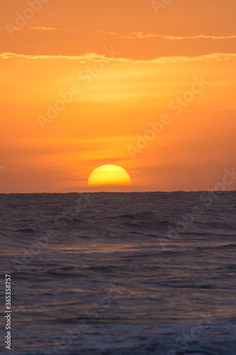 Fototapeta Naklejka Na Ścianę i Meble -  Sunset with rough sea on the beach