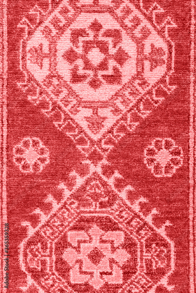 Traditional bright red folk art tribal style floor rug texture.