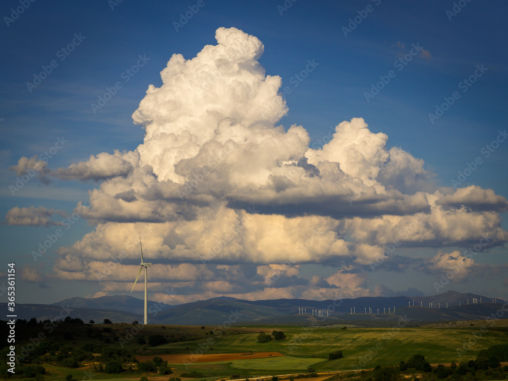 White clouds, windmill and field White clouds, windmill and field