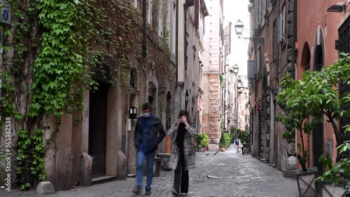 Rome Apt 7th 2020: Boy and girl with masks walk in the streets of Rome