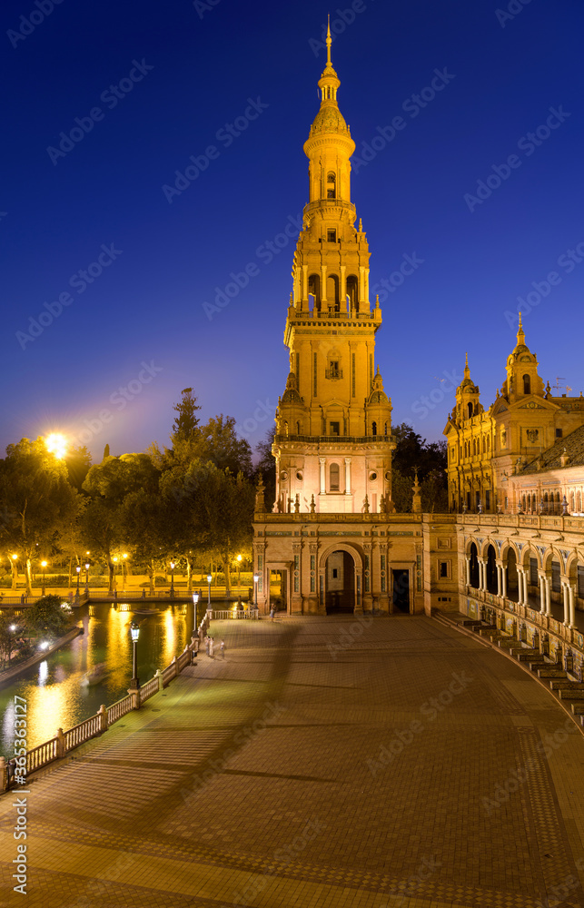 North Tower - A dusk view of illuminated north tower of Spanish Square - Plaza de España, on a clear Autumn evening. Seville. Andalusia, Spain.