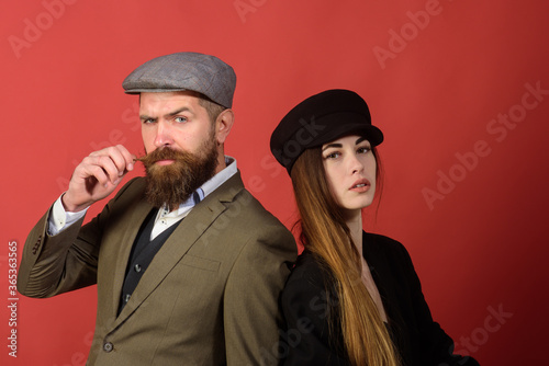 Close up of young fashion retro couple on red background.