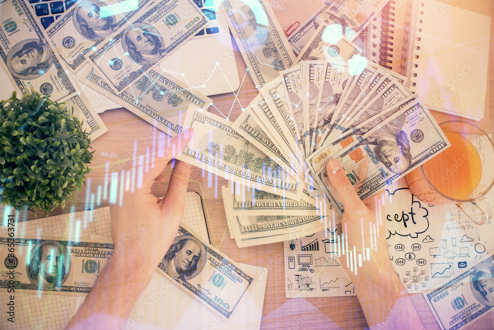 Multi exposure of financial graph drawing hologram and USA dollars bills and man hands. Analysis concept. Multi exposure of financial graph drawing hologram and USA dollars bills and man hands. Analysis concept.
