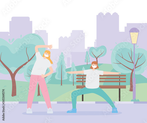 people with medical face mask  girls making stretching sport in urban park  city activity during coronavirus
