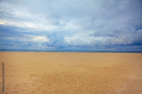 Perfect sandy beach . Beautiful low clouds over the ocean