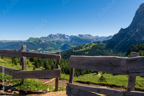 meadow woth wooden fence in the dolomite alps, south tyrol, italy