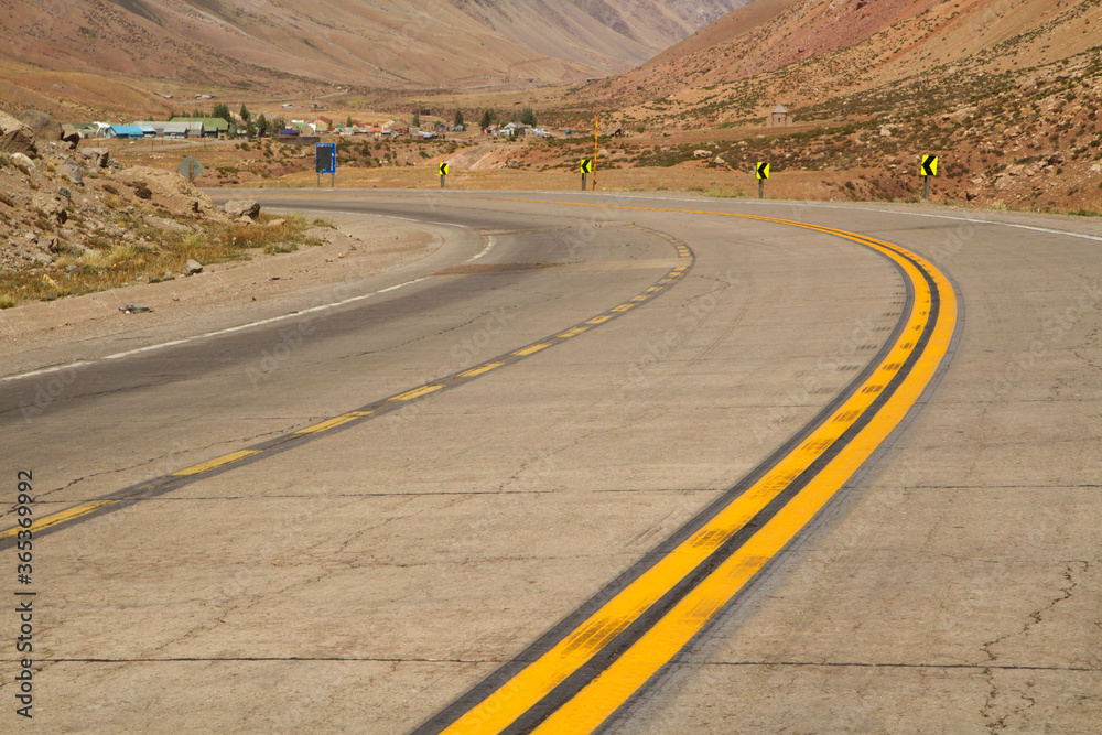 Desert road. Traveling. Closeup of the the asphalt highway in the arid valley and mountains. 