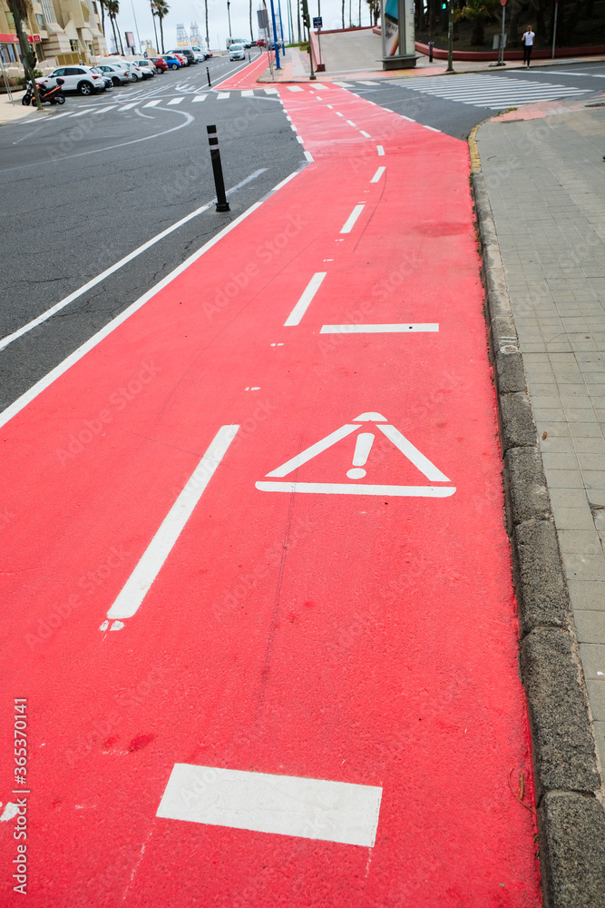 Biking lanes in the city clearly marked with symbols in stencil.