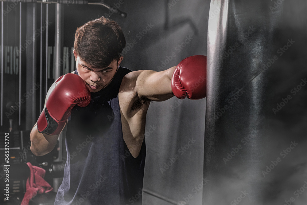 Boxer hitting a huge punching bag at a boxing studio