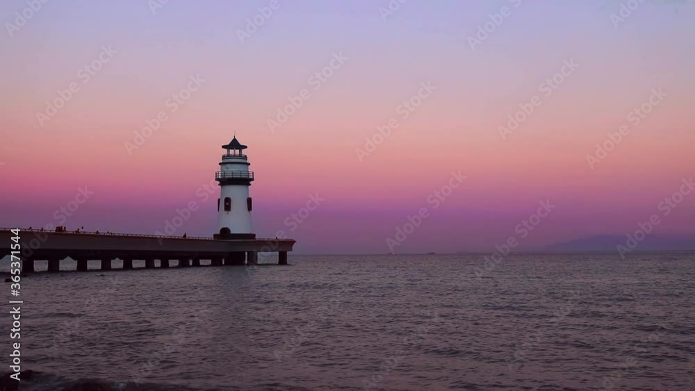 Sunset scenery of Lighthouse at Zhuhai Seaside Swimming Park in Guangdong, China. Pearl River Delta landmark building Sunset scenery of Lighthouse at Zhuhai Seaside Swimming Park in Guangdong, China. Pearl River Delta landmark building