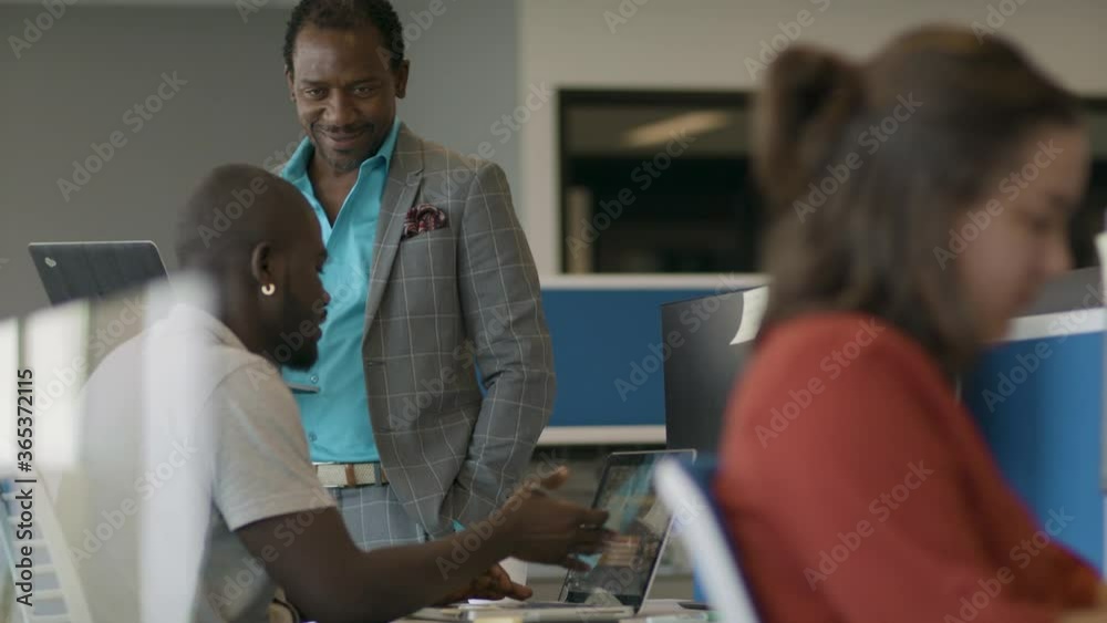 Coworkers collaborating in a modern office. Diversity in the workforce. Tech leaders of the future. Shot in slow-motion and in 4k. Coworkers collaborating in a modern office. Diversity in the workforce. Tech leaders of the future. Shot in slow-motion and in 4k.