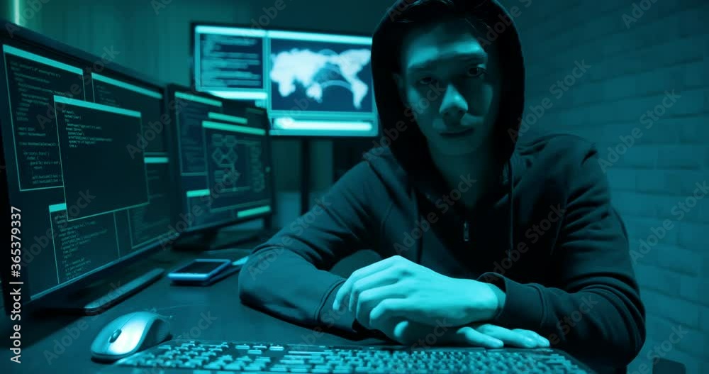 Asian male hacker look screen