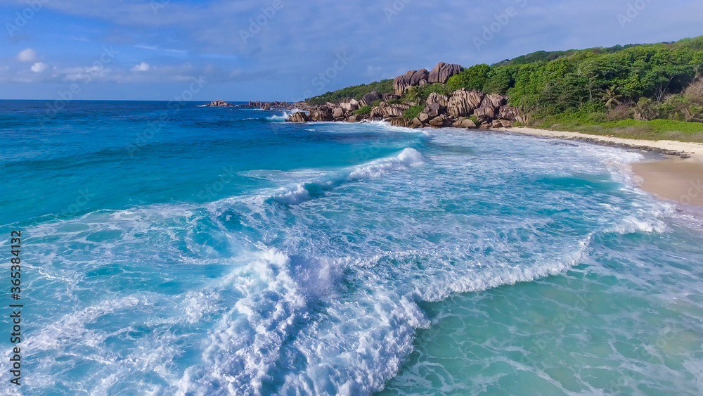 Amazing aerial view of Grand Anse in La Digue Island, Seychelles. Ocean and forest