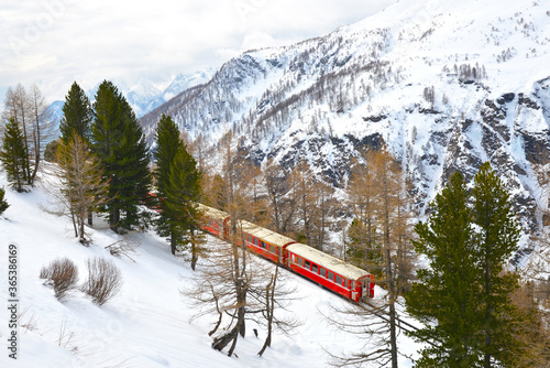 A train passing by Alp Grum station below Bernina express railway