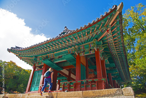 A tourist walking into a building in Changdeokgung secret garden, Seoul, South Korea