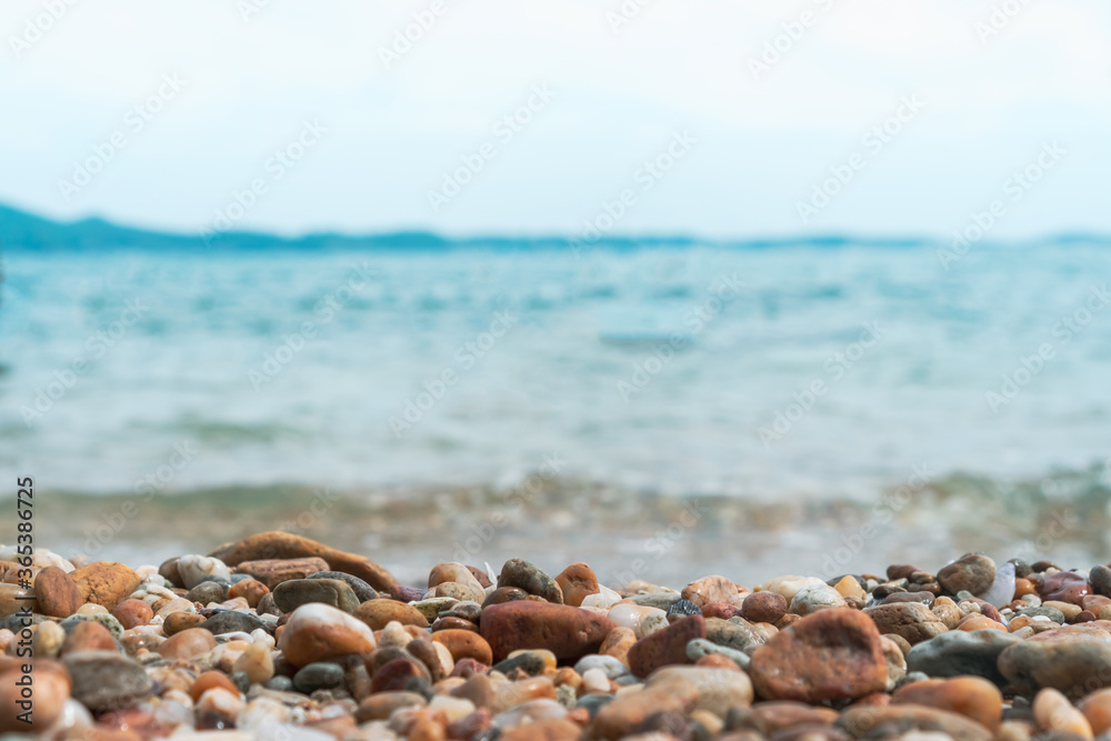 Selective focus on rocks texture with blur beach in background. Selective focus on rocks texture with blur beach in background.