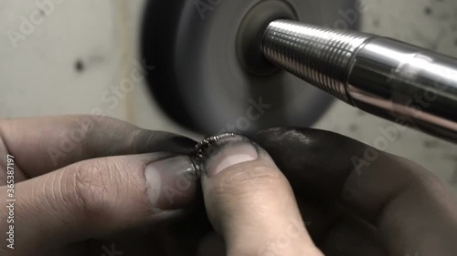 polishing diamond solitaire ring jeweler master. Craftsman hand made diamond ring product. closu up macro shooting