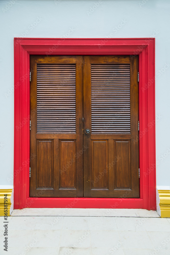 Brown church door. Brown door with a beautiful red frame.