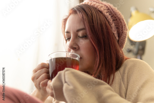 woman drinking coffee on sofa